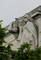 Stone statue of three figures: