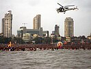 An Indian Coast Guard helicopter patrols Girgaum Chowpatty during Ganesh Immersion