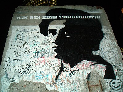 Stencil Graffiti of Rosa Luxemburg on a portion of the Berlin Wall on display in Potsdamer Platzin Berlin. This image was uses in this magazine article.