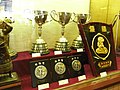 Three cups and rewards are on display
