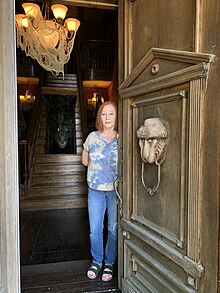 Image of Sandra McKee at the entrance to Munster Mansion replica in Texas