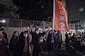 Former members of Scholarism stand in solidarity at the intersection and raise a flag.