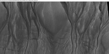 Close-up of channels in gullies showing that the paths of the channels changed over time. This feature suggest formation by running water with a high load of sediment. Picture was taken with HiRISE under HiWish program. Location is the Mare Acidalium quadrangle. Note this is an enlargement of a previous image in Phaethontis quadrangle.