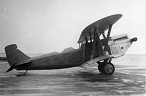 A black and white image of a biplane