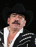 Photograph of Joan Sebastian performing live at the Pepsi Center, wearing a black, traditional Mexican outfit