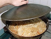 Uzbek plov being prepared in a kazon in a Tashkent home