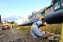 A skilled worker welding a pipe in British Columbia, Canada, in 2014