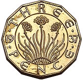 Brass coin depicting a plant