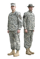 Two soldiers wearing the ACU, as well as a patrol cap (left) and boonie hat (right), both in the Universal Camouflage Pattern.