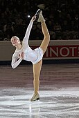 a figure skater performing a spin where the second leg is pointing up