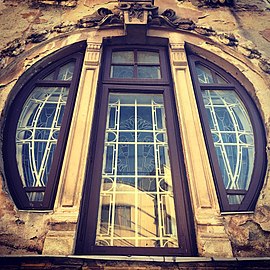 Mixed with Art Nouveau - Stained glass window of the Romulus Porescu House, decorated with lotus flowers, Bucharest, Romania, 1905, by Dimitrie Maimarolu[25]