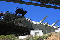 Southwest corner (W2): South side of western concrete end cap/counterweight, westernmost southern deck box to right with alternating walkway-support struts and suspender-cable terminations