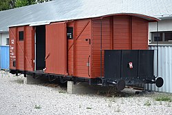 Photograph of a restored train car, with its sliding door open, used to transport Slovak Jews