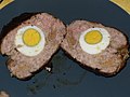 Slices of meat with hard boiled eggs in the middle.