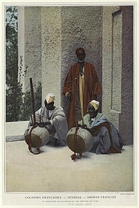 Kora players in Sénégal, 1900. The koras are straight-necked, with handles, carrying cords, tacked skins and small, square soundholes.