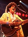 REO Speedwagon's Kevin Cronin playing an Ovation 1984-5 Collectors Series 6-string acoustic guitar during the band's 1984–85 Wheels Are Turnin' tour