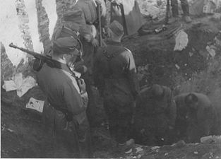 NARA copy #20, IPN copy #19 A bunker being opened Stroop witnesses digging out of a bunker, possibly near the ghetto wall. 8 May 1943