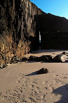 View from the beach through the Zawn Pyg rock arch