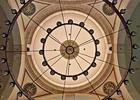 Intricate inscriptions surround an inner dome shot from below