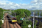 A Class 314 train leaves Gourock pierhead to run along the south bank of the Firth of Clyde towards Glasgow.