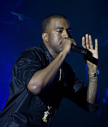 A photograph of Kanye West performing live.