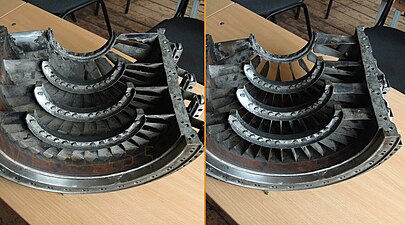 These photographs of a damaged compressor case illustrate the angular travel of variable stators and the meaning of the terminology, open and closed. It shows stator vanes closed for starting and low speed running (left photograph) and open for higher speeds. Klimov TV2-117 turboshaft compressor with pr 6.6:1