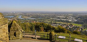 Looking northeast towards Barkhausen (foreground), the River Weser, the Green Bridge (old railway bridge), the B 65 bridge (behind) and the village of Neesen on the other side of the river Weser