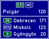 Route confirmation sign with an indirect destination in Hungary.