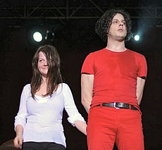 Jack and Meg White standing together onstage