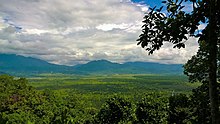 Lowlands, with mountains in the background under a cloudy sky