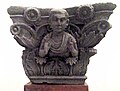 Indo-Corinthian capital representing a Buddhist devotee wearing a Greek cloak (chlamys) with fibula. Butkara Stupa, National Museum of Oriental Art, Rome.
