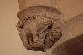 Photographie en couleur d'un détail sculpté représentant un sanglier.