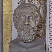 Bust of a somewhat elderly and rather tired-looking man with a short, curly beard, vaguely similar to Greek busts of Homer