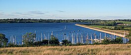 A lake with pleasure craft docked in the foreground