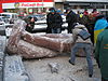 Toppled Lenin statue being broken into pieces for souvenirs