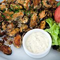 Gebakken mosselen (fried mussels) are cooked mussels fried with butter and onions