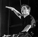 Black and white photo of Martin Garrix using his DJ turn tables