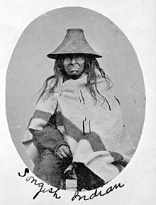 Man wearing straw hat and blanket