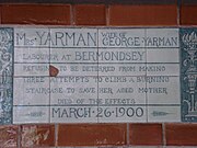 A tablet formed of six standard sized tiles, bordered by green flowers in the style of the Arts and Crafts movement