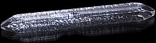 A long, thin quartz crystal