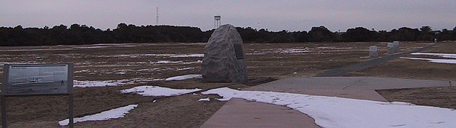 The first powered flight site from the east. The monument in the center was established in 1928.