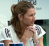 A blond-haired women wearing a white shirt