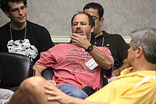 Steve Greenberg (center) speaks at Kinnernet on May 9, 2009. AOL founder Steve Case (foreground) observes.