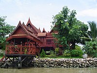 Traditional Thai-style stilt house on a canal near the Chao Phraya River in Bangkok.