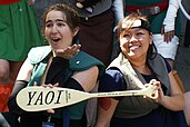 Cosplayers holding a yaoi paddle