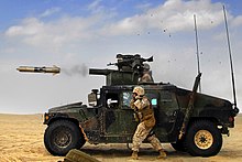 a TOW missile leaves the tube of a HMMWV-mounted launcher