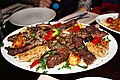 Mixed Arabic meat platter served on a bed of rice, in a restaurant in the United Kingdom