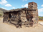 The Flying "V" Cabin was built in 1880 and was located in Canyon Creek, Young, Arizona. The cabin has notched gun ports which were used on July 17, 1882, during the Battle of Big Dry Wash, the last Apache War in that area. John D. Tewksbury Sr., of Pleasant Valley War fame lived here with his two wives and children.[59]