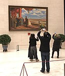 Tourists take photographs of the painting
