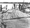 A wooden dock-like structure crossing a lake